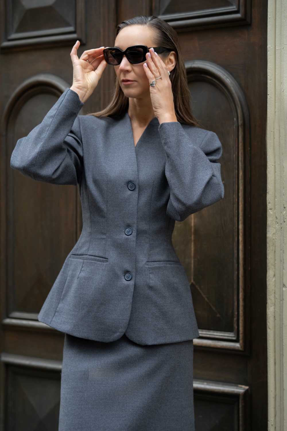 Elegantiškas pilkas švarko ir sijono kostiumėlis